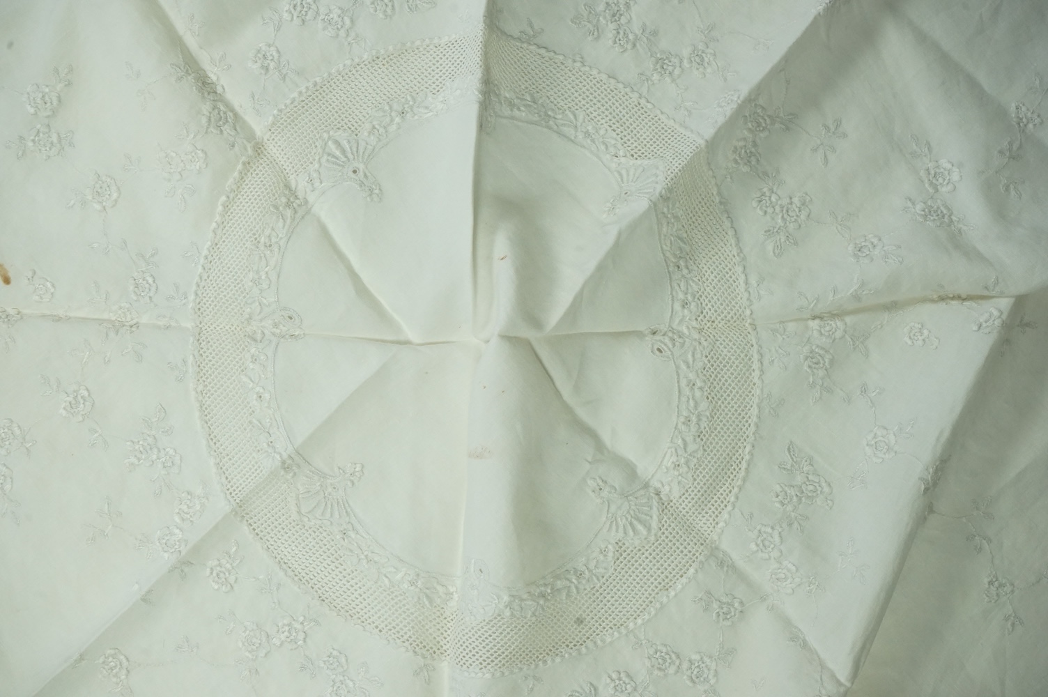 An unusual Victorian white linen hand worked table cloth. Embroidered along one edge, Wrought by L. Grover for her daughter Ethel Frances Burbury 1895. Together with three crochet edged cloths and a circular embroidered